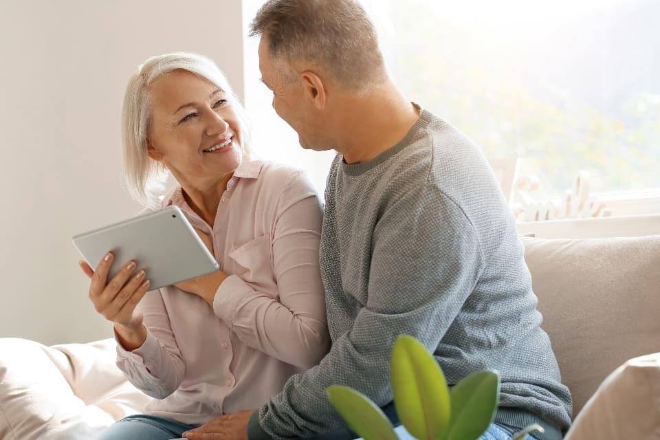 Älteres Paar schaut gemeinsam auf ein Tablet